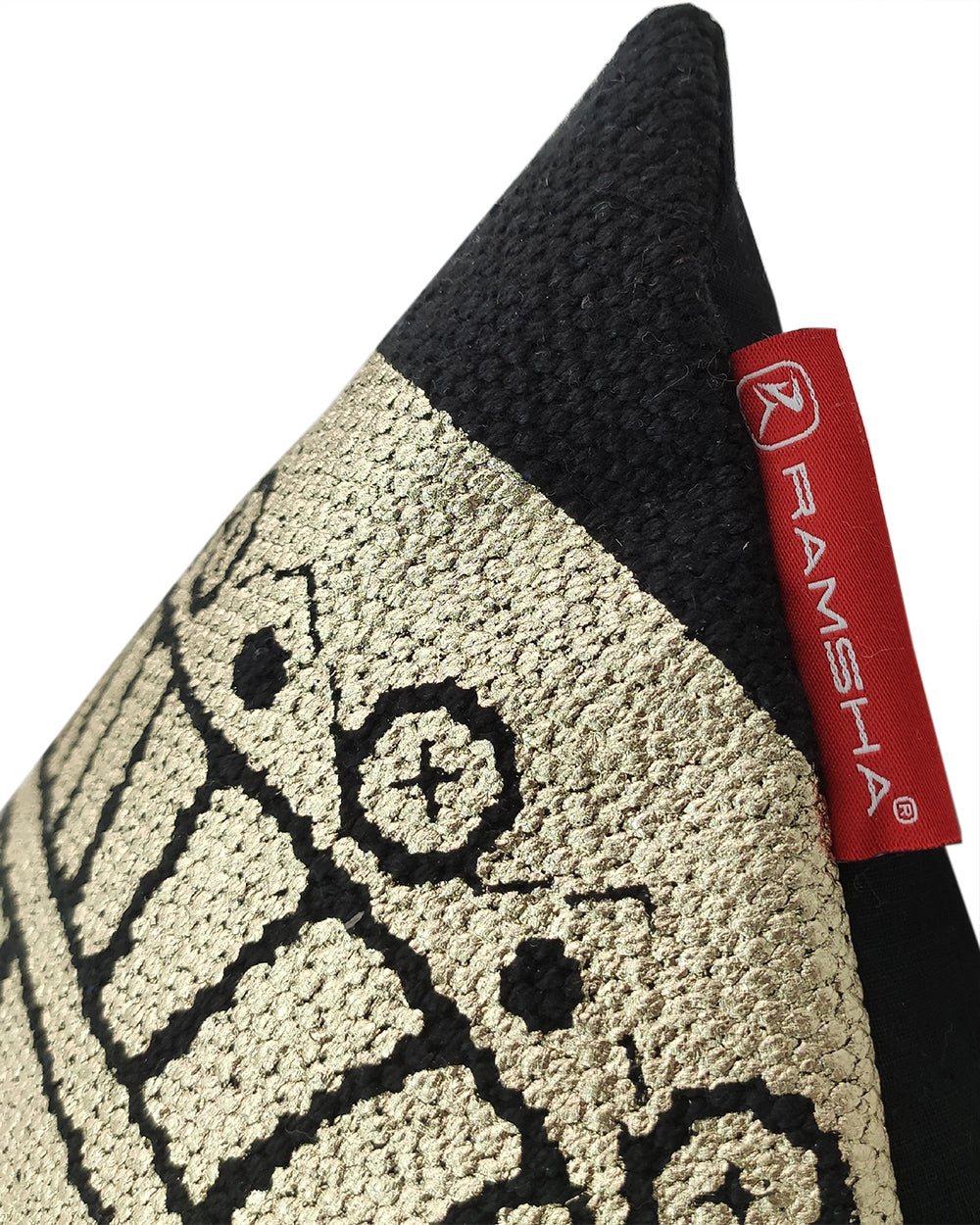 Close-up of the Gold And Black Foil Printed Cushion CS-198 by RAMSHA HOME, showing a textured geometric gold and black pattern and a red RAMSHA HOME fabric tag on the seam.