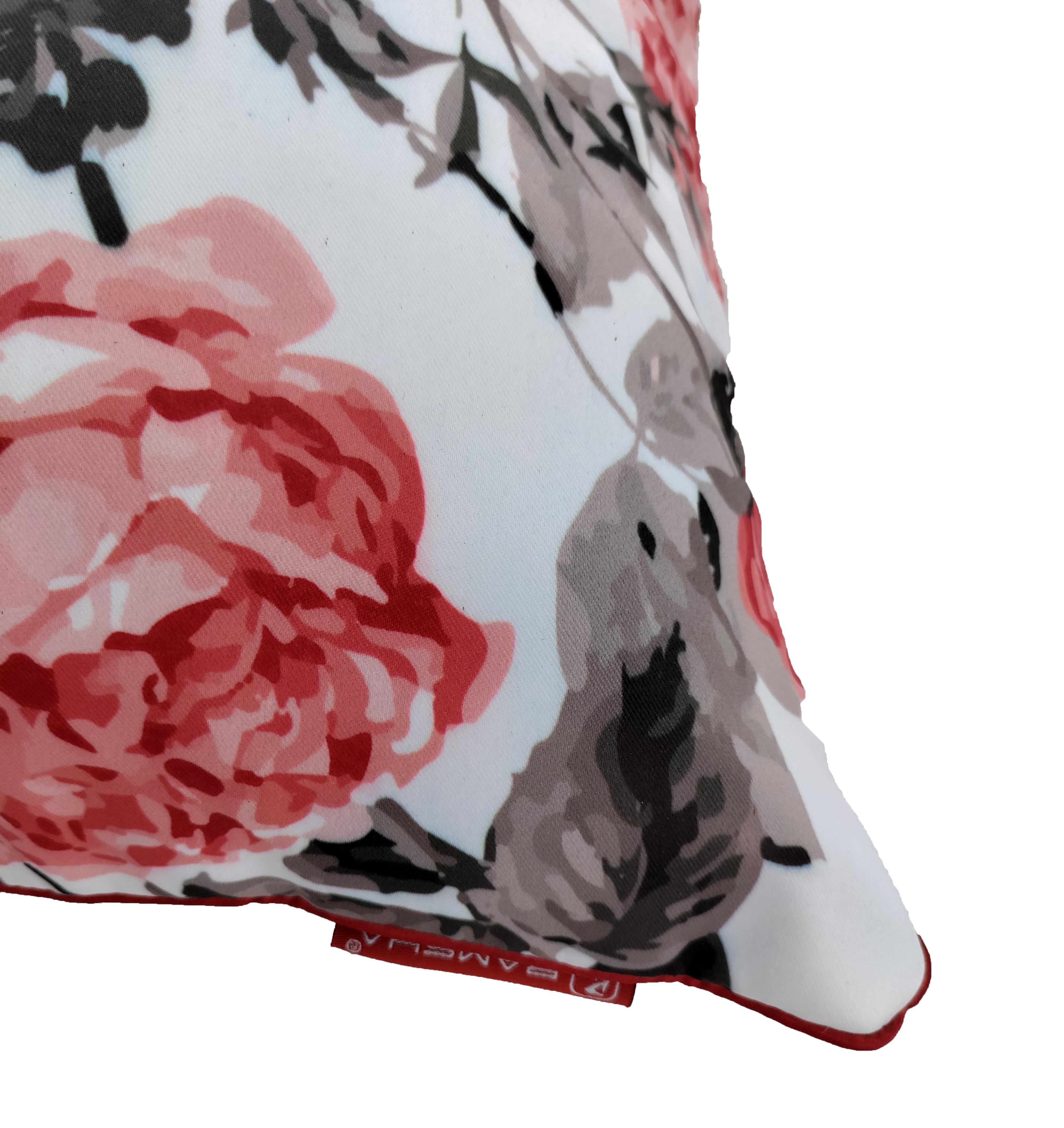 The RAMSHA HOME Floral Printed Multi Color Cushion features pink, red, and gray flowers and leaves on a white background, with a visible seam tag that adds a stylish touch to your home decor.