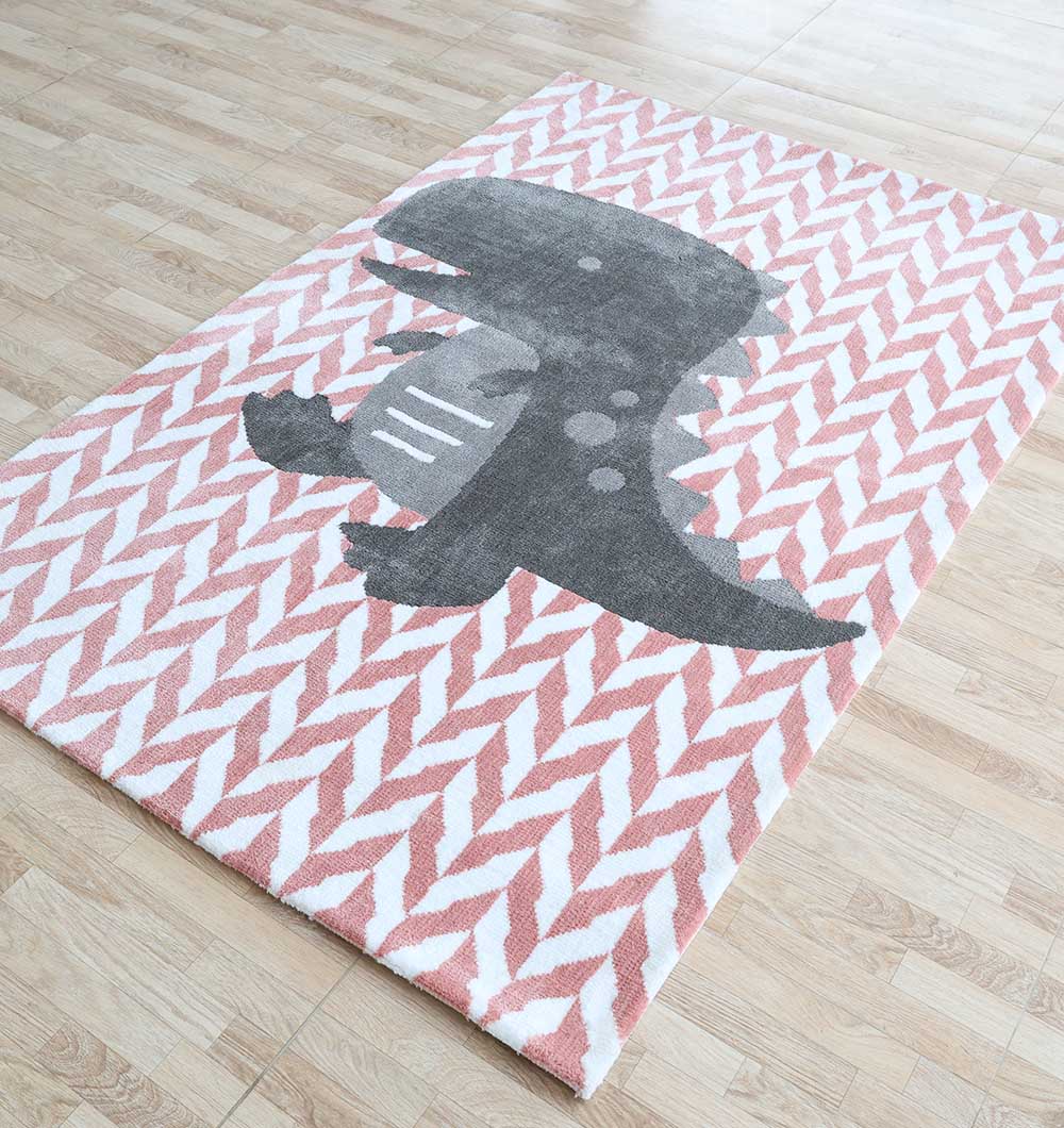 The RAMSHA HOME Kids Dinosaur Rug - Pink Grey Playroom Area Carpet (KD 007, 120x180 cm) features a cute gray dinosaur on a pink and white chevron background—ideal for adding fun to any light wood floor.