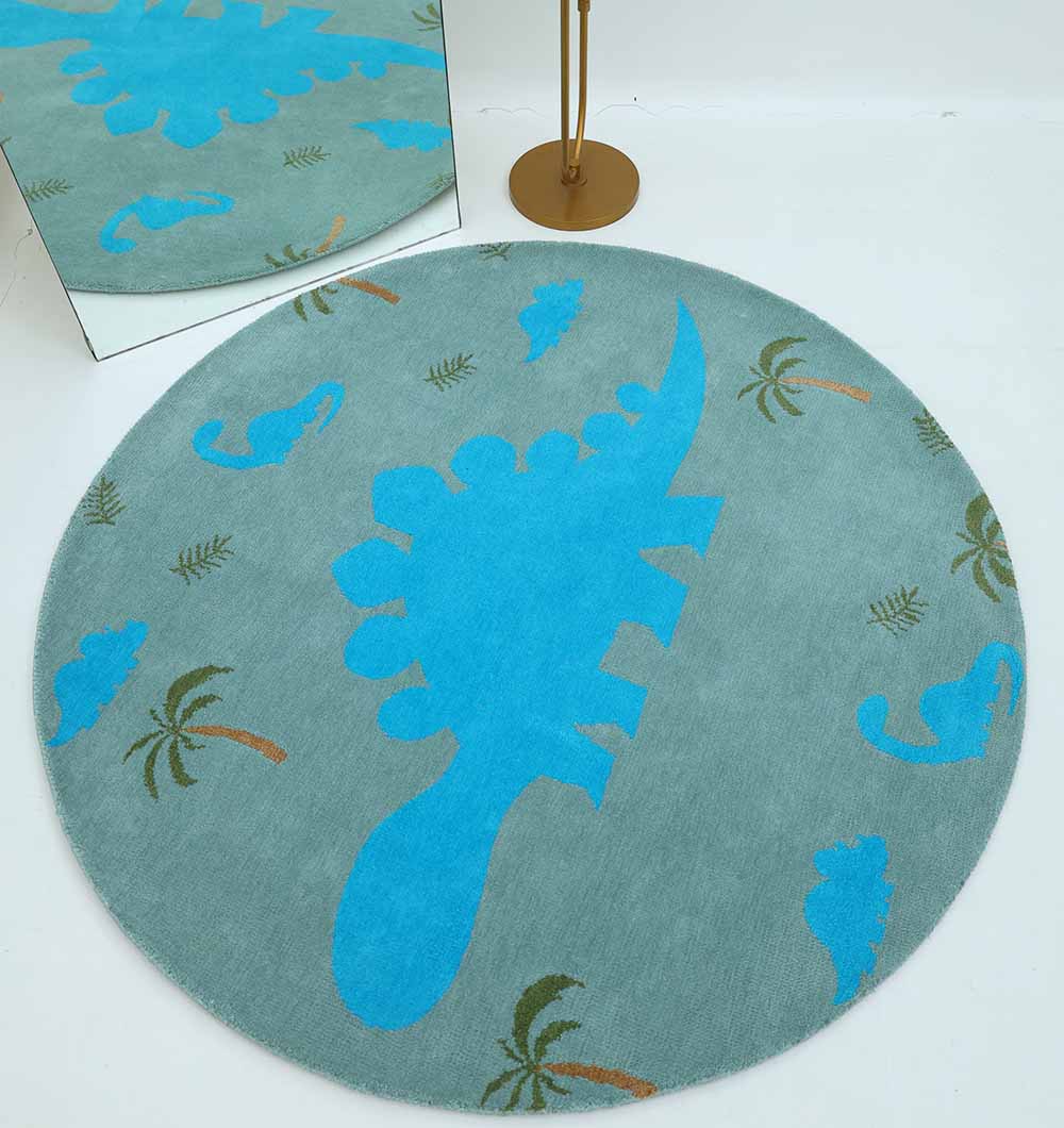 The RAMSHA HOME Kids Dinosaur Rug (KD 008, 150 cm) in blue and green showcases a large central blue dinosaur, smaller dinosaur silhouettes, and green palm trees, creating a playful playroom look when paired with a mirror and gold floor lamp.