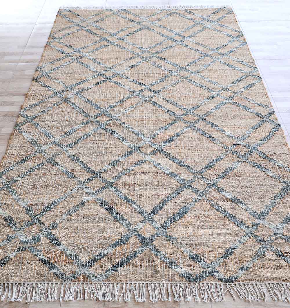 The RAMSHA HOME Fringes Jute & Cotton Kilim Flatweave Carpet - KLM 002 (170x240cm) features a blue and beige diamond pattern with fringed edges, adding texture and style to any light wooden floor.