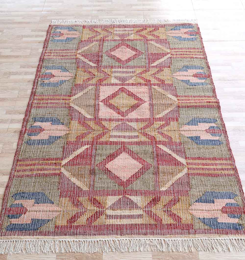 The RAMSHA HOME Handwoven Diamond Patterned Kilim Rug - KLM-010 (170x240cm) features geometric red, pink, gold, blue, and beige designs with symmetrical diamond motifs, shown here on a light wood floor.