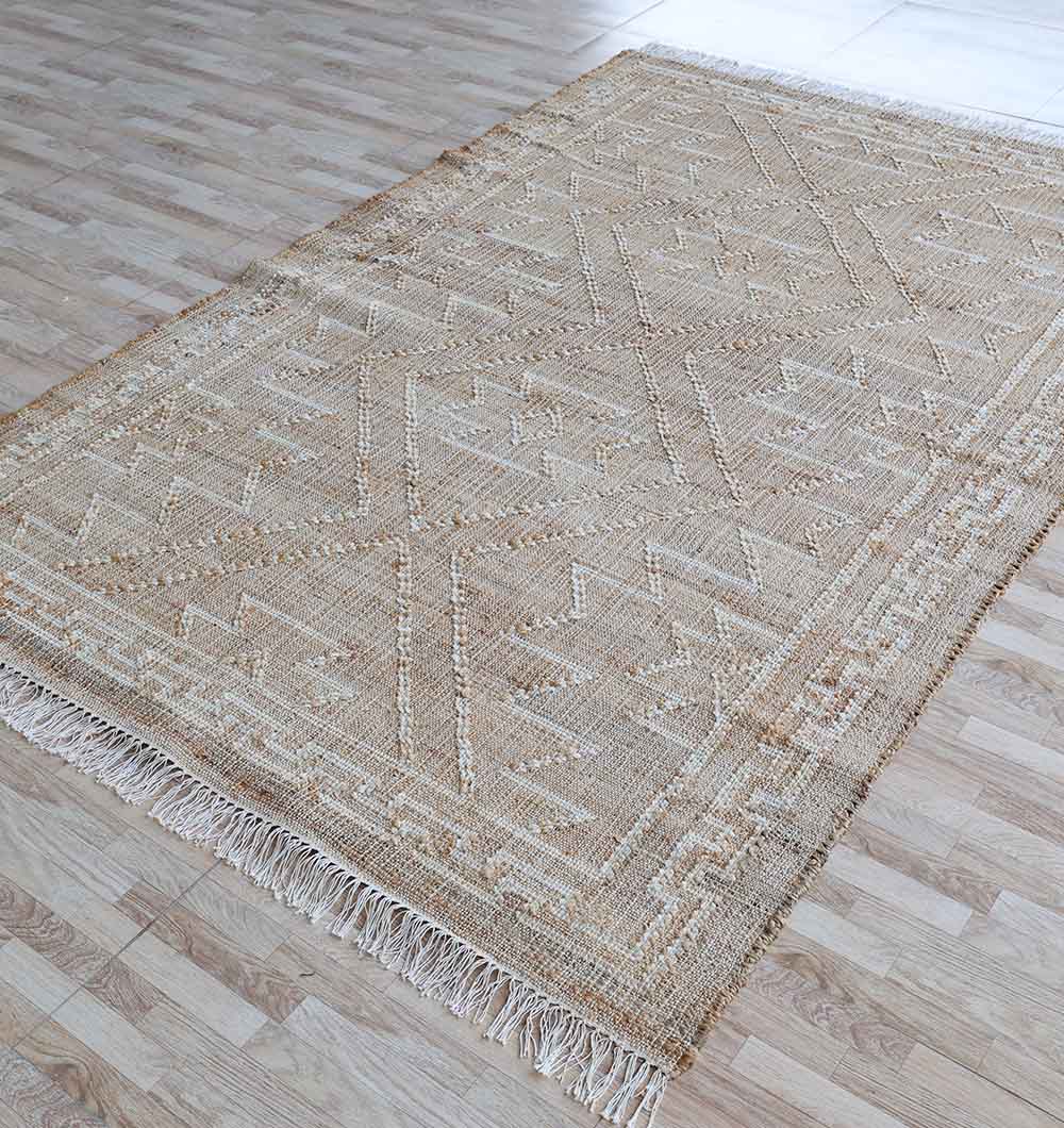 The RAMSHA HOME Jute Cotton Blend Kilim Rug KLM 012 (170 x 240 cm) features a beige and light brown geometric design with fringed edges, shown here on a light wooden floor.