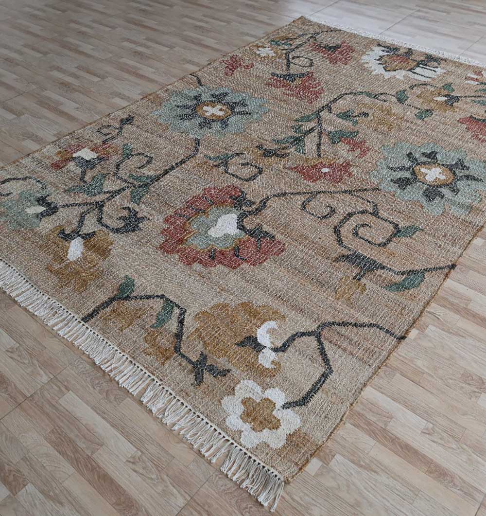 The RAMSHA HOME Handmade Kilim Rug – Natural Floral Style Flatweave Carpet KLM-020 features a floral and vine pattern in earthy green, brown, yellow, and red tones with a fringe edge, adding warmth and charm to light wooden floors.