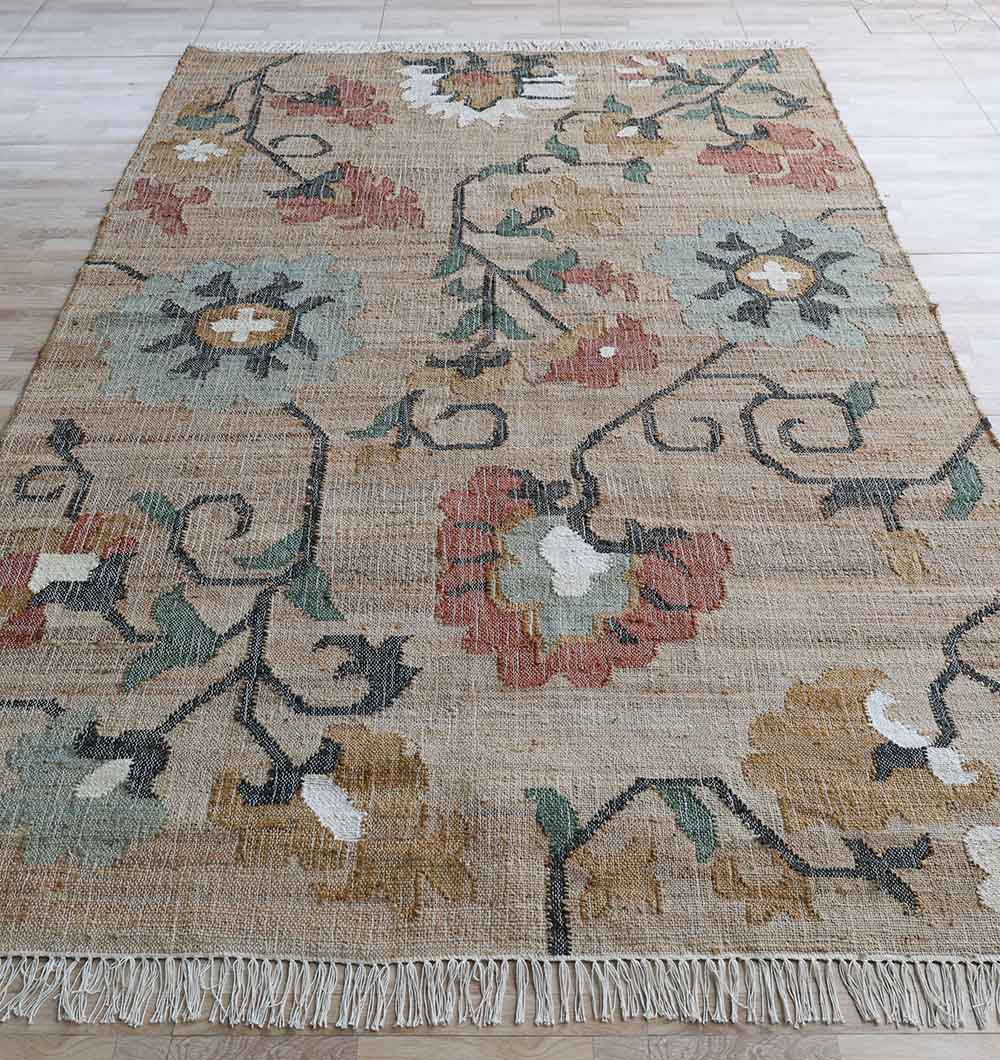The RAMSHA HOME Handmade Kilim Rug – Natural Floral Style Flatweave Carpet KLM-020 displays large, stylized flowers in muted red, green, yellow, and blue on beige with fringed edges—ideal for neutral interiors and light wood floors.