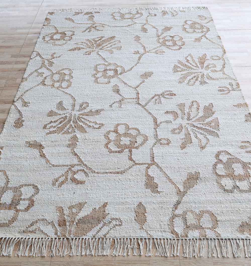 The RAMSHA HOME Kilim Rug - Natural Handmade Flatweave Carpet (KLM 022) features a beige and light brown large botanical pattern, textured surface, and fringed edges, shown here on a light wood floor.