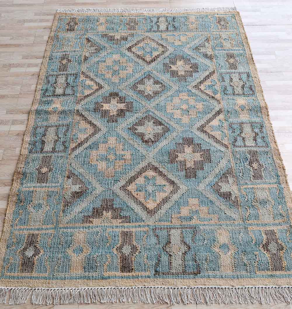 The RAMSHA HOME Handmade Kilim Rug 170x240 cm (KLM-023) features multicolor geometric diamond and cross motifs in blue, beige, and brown with fringed edges, beautifully displayed on a light wooden floor.