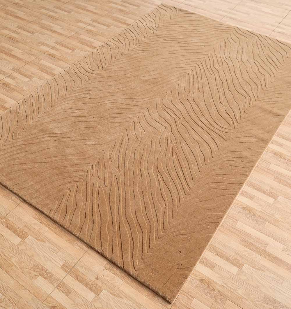 The RAMSHA HOME Decorative Handmade Beige Color Area Rug (LKH-028) features a subtle wavy texture and lies on a light wood floor, with its tan tones blending seamlessly to create a warm, cohesive space.