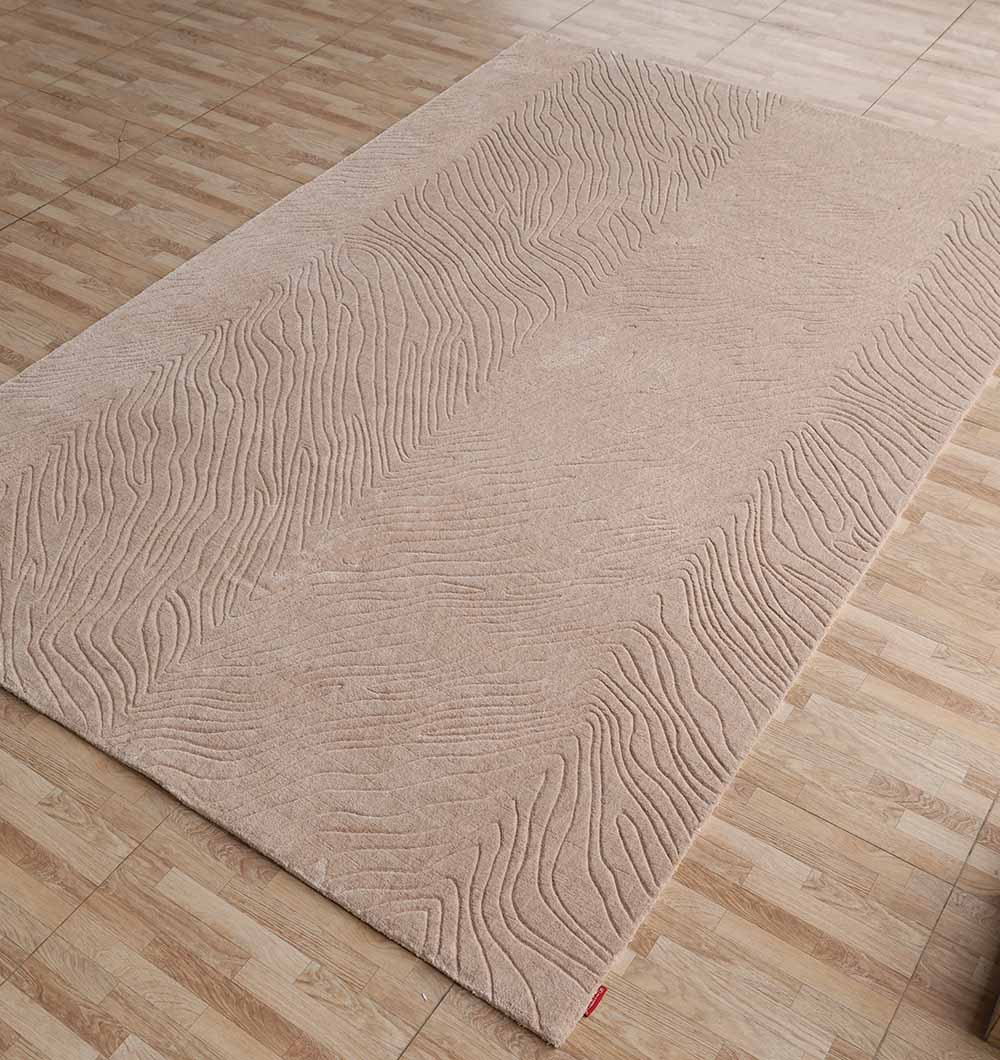 The RAMSHA HOME Rectangle Handmade Beige Color 200x300 cm Area Rug (LKH-040) features textured, wavy raised lines for a subtle, modern look on light wood-patterned floors.
