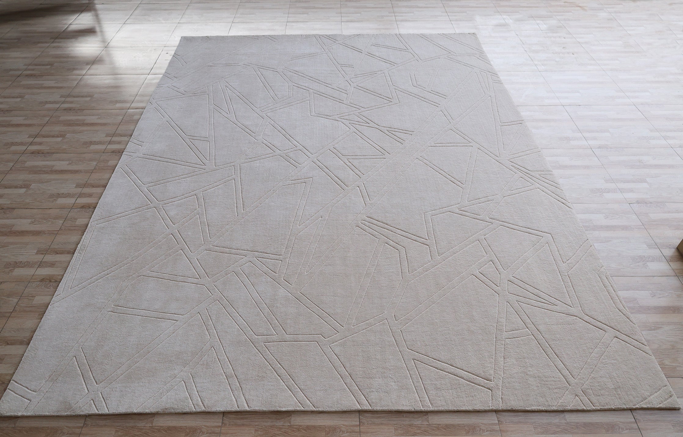 The RAMSHA HOME Rectangle Home Decor Cream Color Handmade Area Rug (300x400 cm, LKH-045) with an abstract geometric line pattern is laid on a light wood floor in a spacious room.