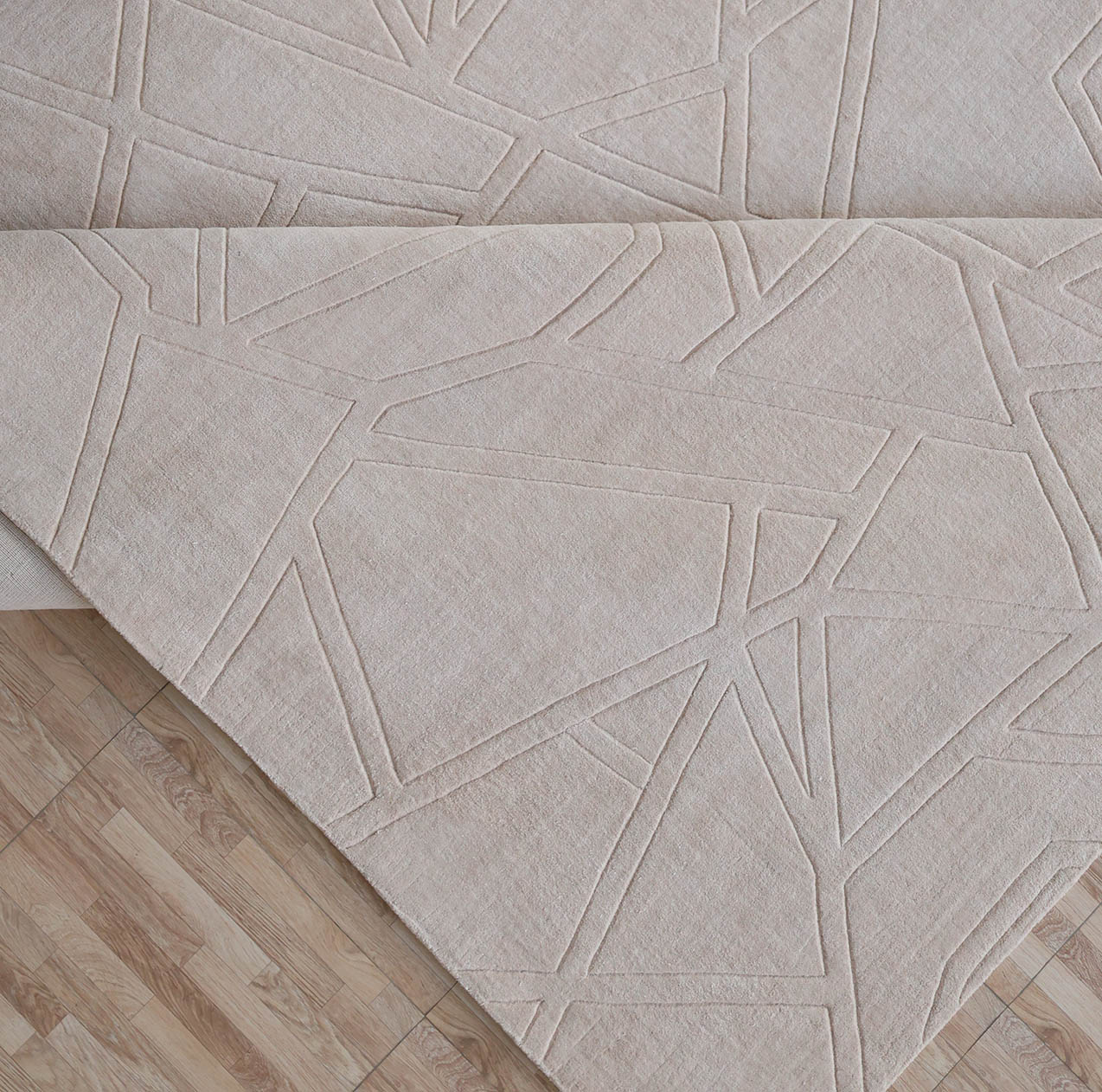 The RAMSHA HOME Rectangle Home Decor Cream Color Handmade Area Rug (300x400 cm, LKH-045) features a subtle raised geometric pattern and is shown partially folded on a wooden floor, revealing both the front and back.