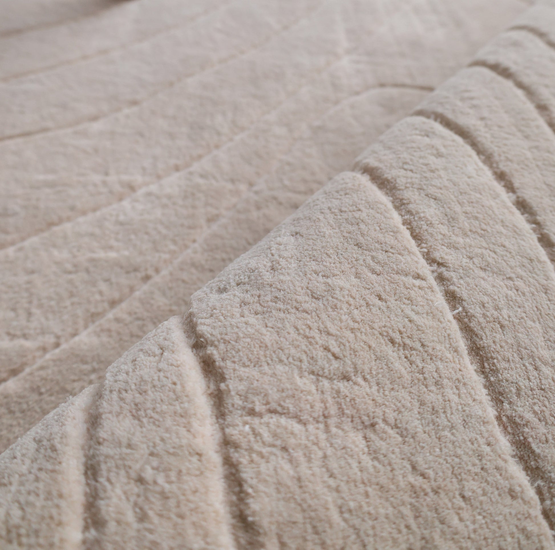 Close-up of RAMSHA HOME's Modern Handmade Area Cream Color Rug (300x400 cm, LKH-046), showing its soft, handwoven texture with raised, curved parallel lines that add depth and gentle movement to any space.