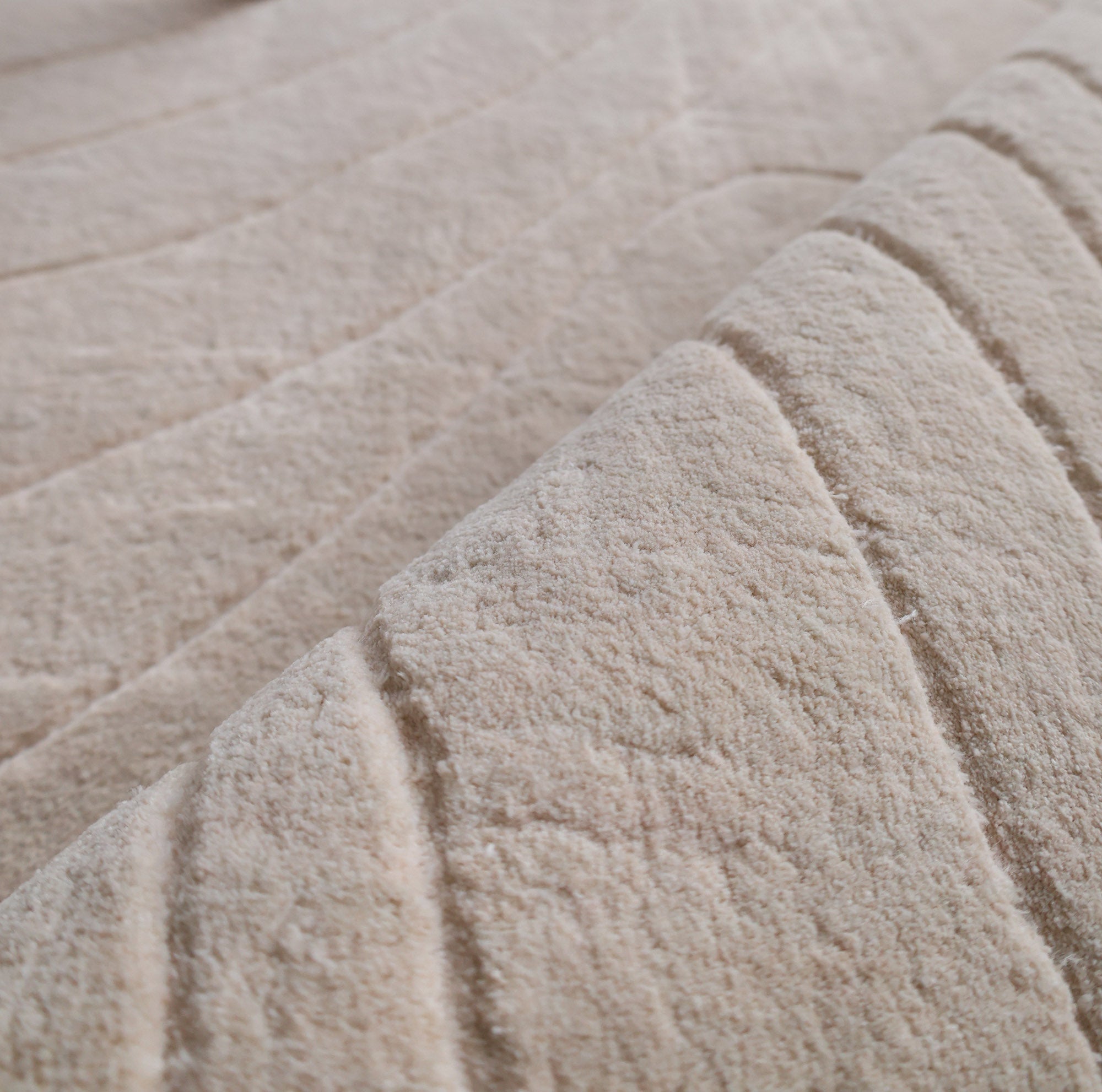Close-up of RAMSHA HOME's Modern Handmade Area Cream Color Rug (300x400 cm, LKH-046), showing its soft, handwoven texture with raised, curved parallel lines that add depth and gentle movement to any space.