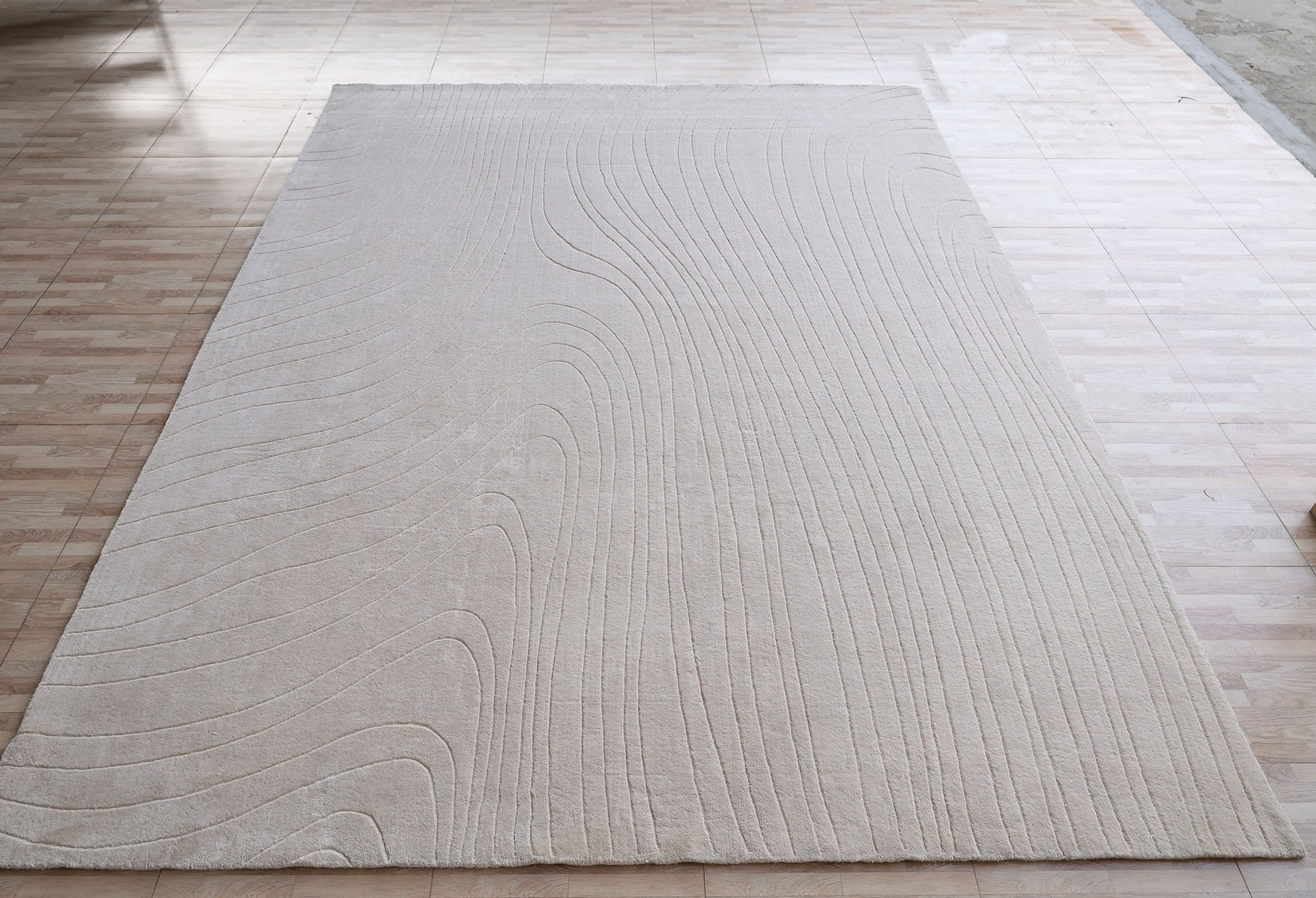 The RAMSHA HOME Modern Handmade Area Cream Color Rug (300x400 cm, LKH-046) features subtle curved line patterns and is placed on a tiled floor in a well-lit room.