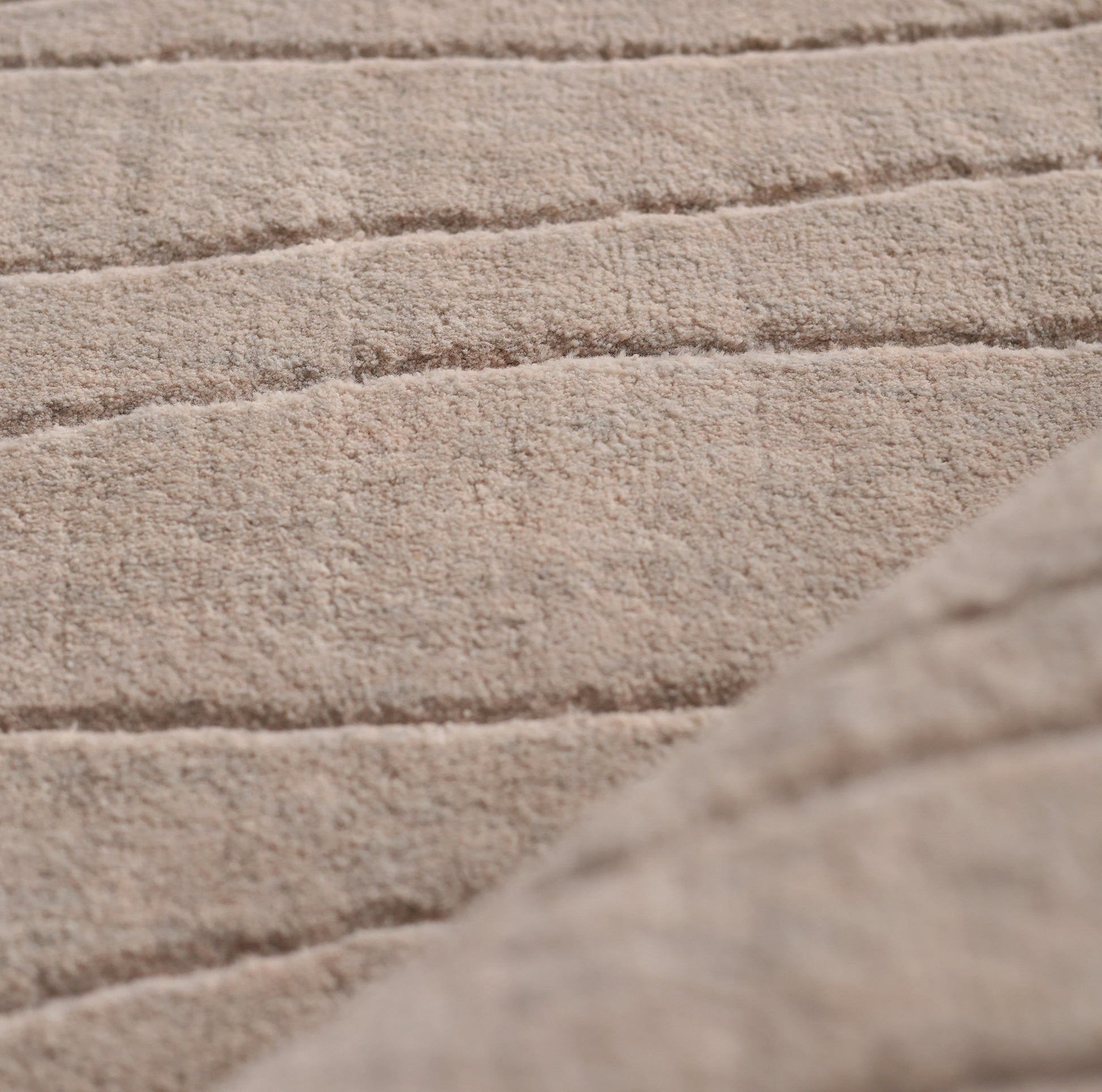 Close-up of the soft, textured surface with horizontal stitching on the RAMSHA HOME Light Grey Color Handmade Area Rug 250x350 cm (LKH-043), showcasing a cozy, quilted look and slightly raised pattern.