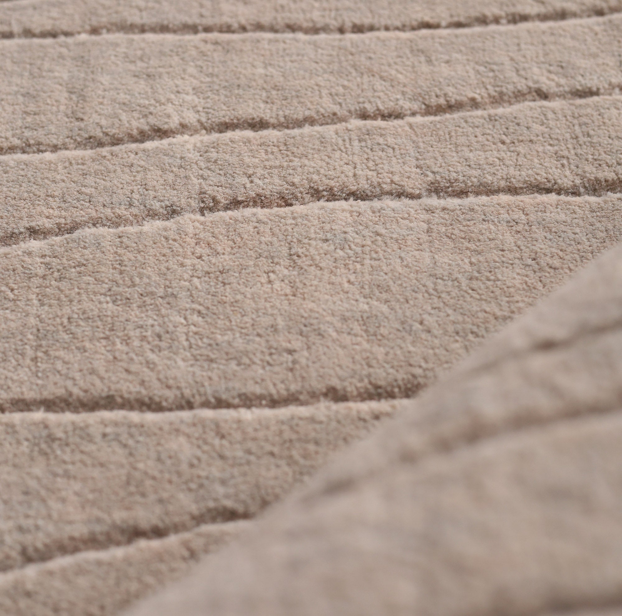 Close-up of the soft, textured surface with horizontal stitching on the RAMSHA HOME Light Grey Color Handmade Area Rug 250x350 cm (LKH-043), showcasing a cozy, quilted look and slightly raised pattern.