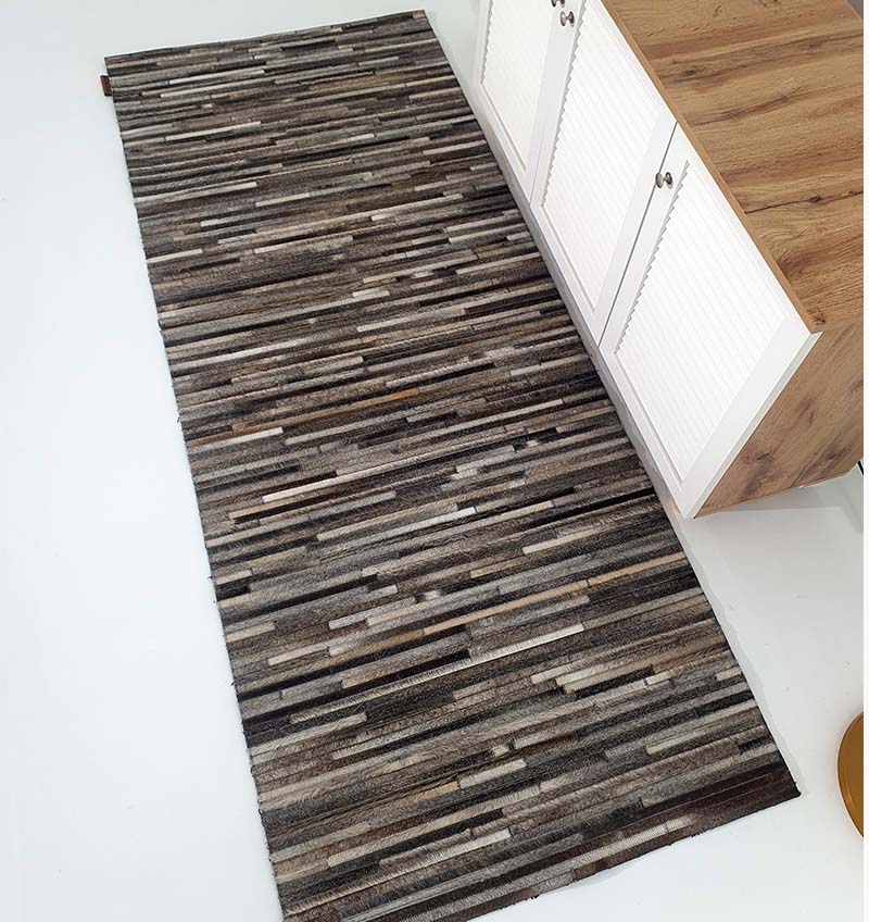 Top-down view of the leather runner rug, showcasing the long rectangular shape and robust underlay structure designed for narrow spaces.