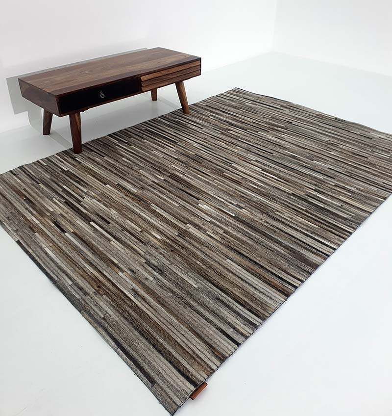 Rectangular leather and wool rug in home decor, functioning as a hard-wearing room foundation with a layered build.