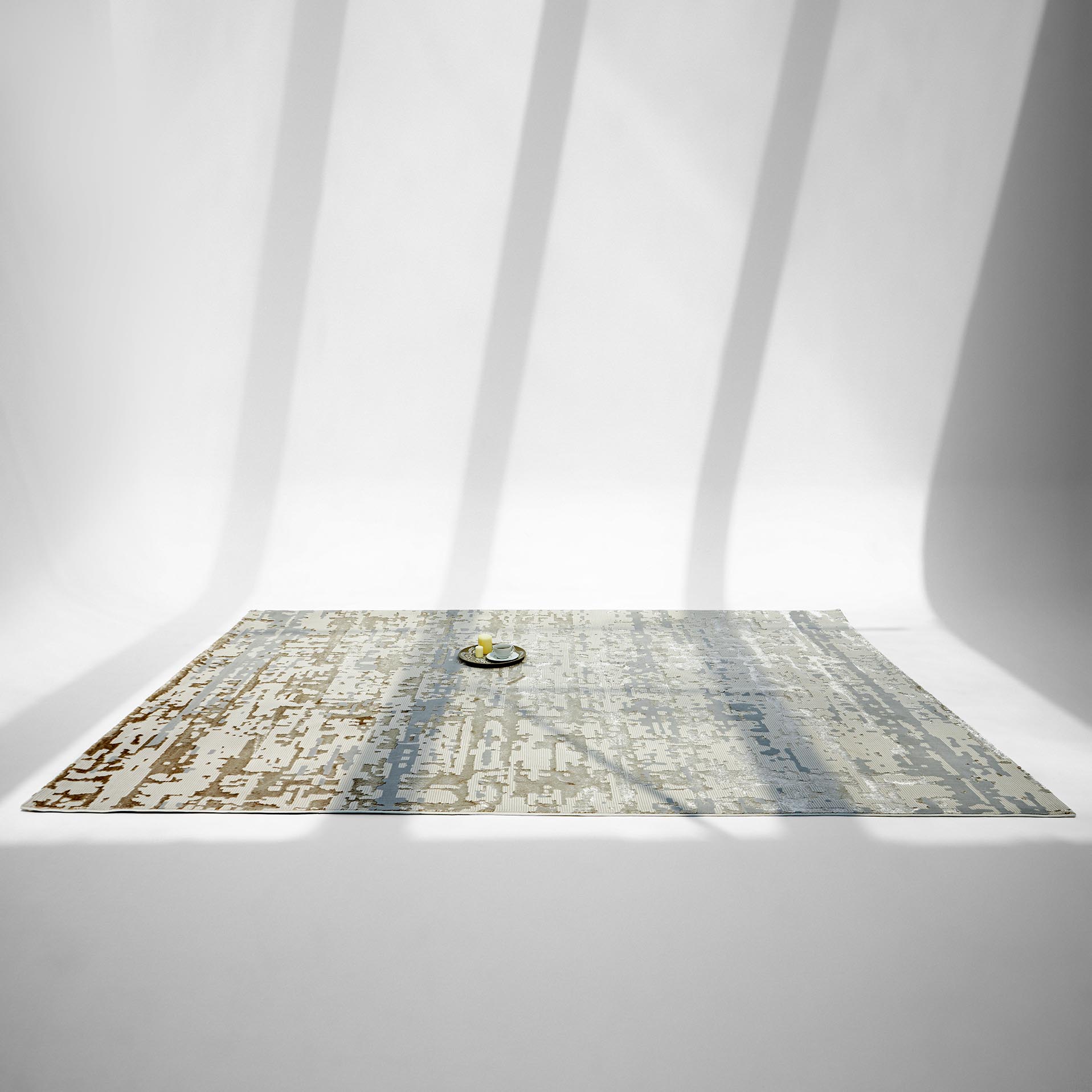 The RAMSHA HOME Stunning Abstract Pattern Machine Made Rug - MZ40K, a large stain-resistant piece in neutral tones, is displayed on a white background with diagonal shadows. A small bowl holding a lemon sits near its center.