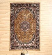 The RAMSHA HOME Persian Floral Medallion Rust & Black Border Rug – MMB 09 (175x275 cm) lies on a light wooden floor, featuring intricate patterns in rust, black, and white with a black chair partially visible at the bottom.