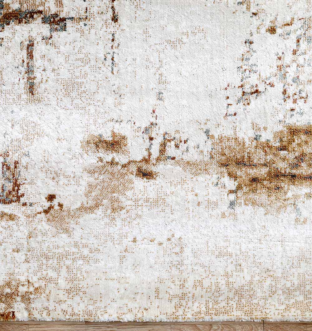 A close-up of the RAMSHA HOME Abstract Distressed Beige & Brown Rug – MMB 11 (235x330 cm), showing its plush, mottled pattern in cream, beige, and brown tones as it covers a wooden floor.