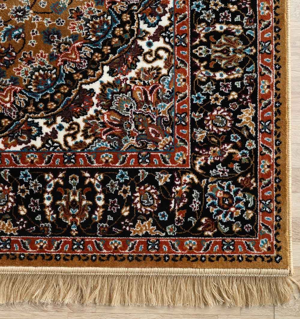 Corner of the RAMSHA HOME Persian Floral Medallion Rust & Black Border Rug – MMB 15 (235x330 cm), machine-made polyester with intricate floral patterns and beige fringe, shown on a light wooden floor.