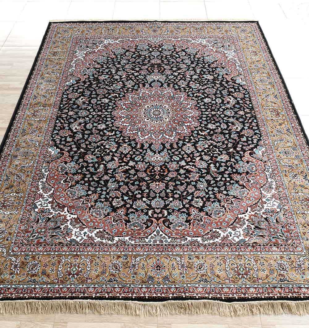 The RAMSHA HOME Persian Floral Medallion Black & Gold Rug – MMB 18 (265X365 cm) showcases detailed floral patterns, a decorative border, and tasseled edges, elegantly displayed on a tiled floor.