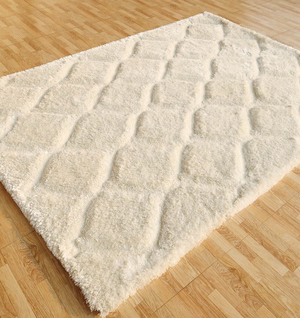 The RAMSHA HOME White Rectangle Shaggy Rug with Carved Diamond Pattern (MP3D 13) adds a cozy, textured look to your room with its plush pile and geometric design, shown here on a light wood floor.