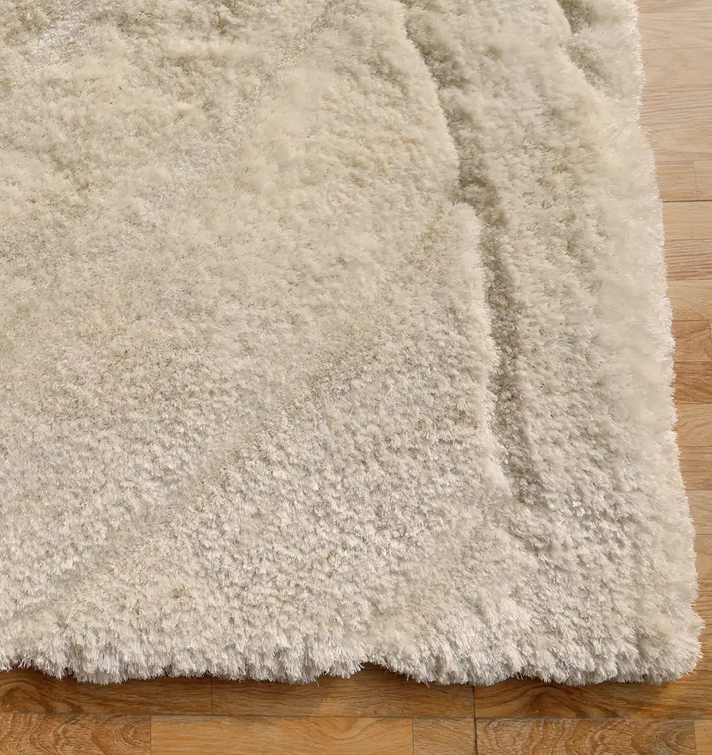 The RAMSHA HOME Textured White Shaggy Area Rug for Large Living Room (MP3D 07) features a plush, thick pile with soft texture and subtle shading, creating a cozy and inviting look on any light wooden floor.