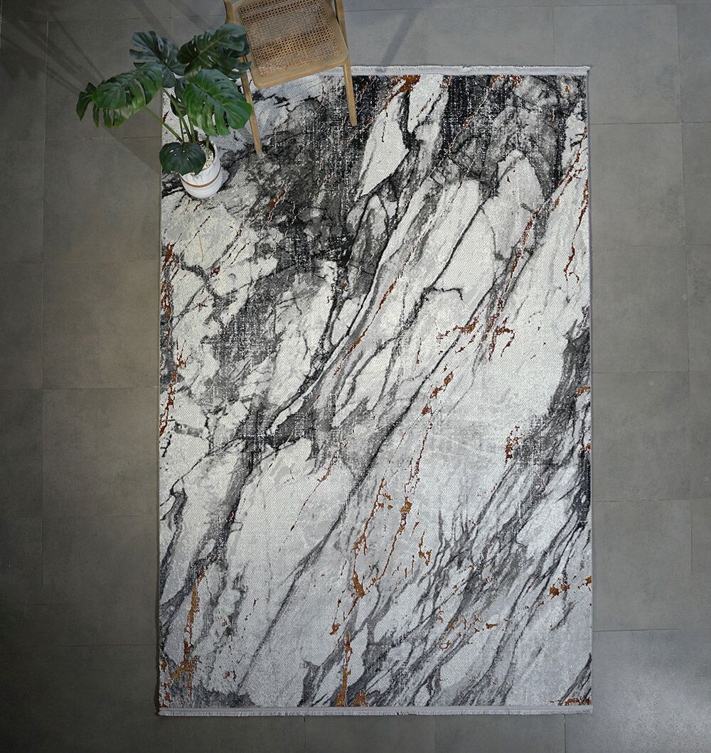 The RAMSHA HOME Decorative Machine Made Turkish Rug - MR327 FLORENCE features a modern marble design in gray, black, and rust on a tiled floor, with a wooden chair and potted plant accenting this stylish grey and white rug.