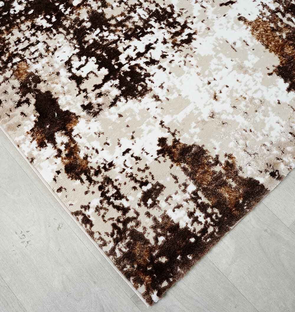 The RAMSHA HOME Beige & Dark Brown Turkish Area Rug - N371B MADRID, featuring a modern abstract pattern in brown, beige, and white, is displayed on a light wood floor.