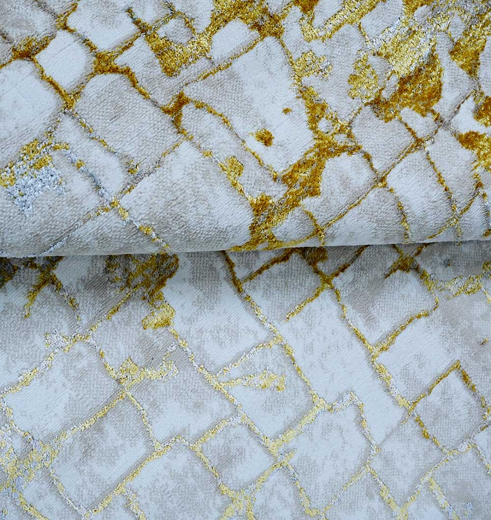 Close-up of the Abstract Machine Made Ivory & Yellow Turkish Area Rug - NK81A MADRID by RAMSHA HOME, featuring an irregular gold and yellow pattern over light grey, blending modern style with subtle Persian-inspired motifs.