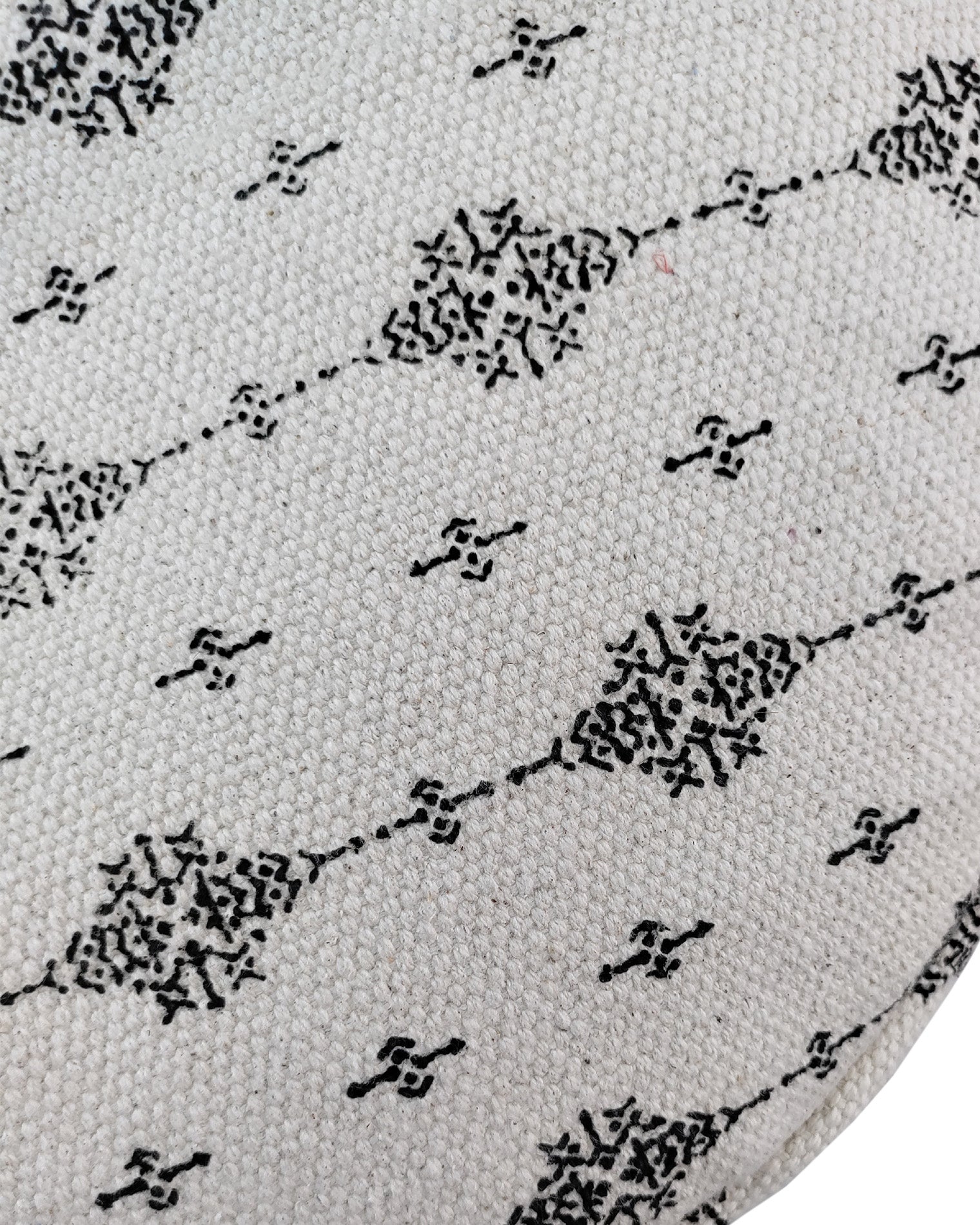 Detailed view of a black and white woven cotton pouf featuring fringe edges, ideal for chic and contemporary home décor.