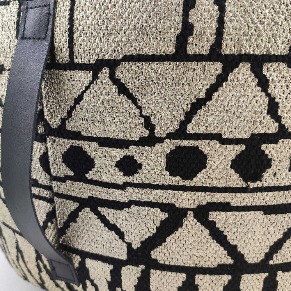 Detailed image showing the fine craftsmanship, woven cotton pattern, and durable leather handle of the PF-093 pouf.