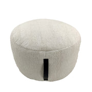 Handmade white cotton pouf with sturdy side handle, featuring soft textured fabric and a cozy round design for modern interiors.