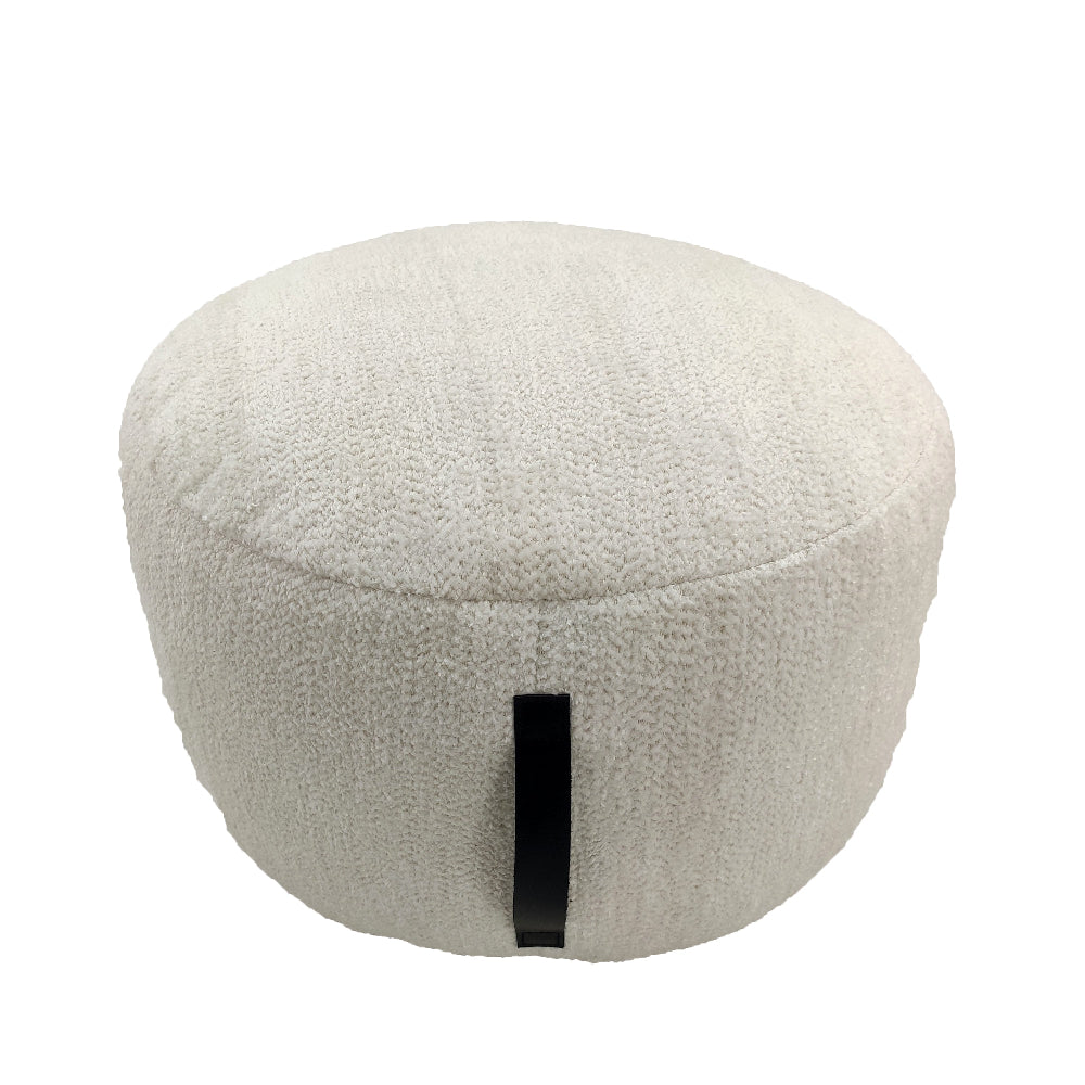 Handmade white cotton pouf with sturdy side handle, featuring soft textured fabric and a cozy round design for modern interiors.