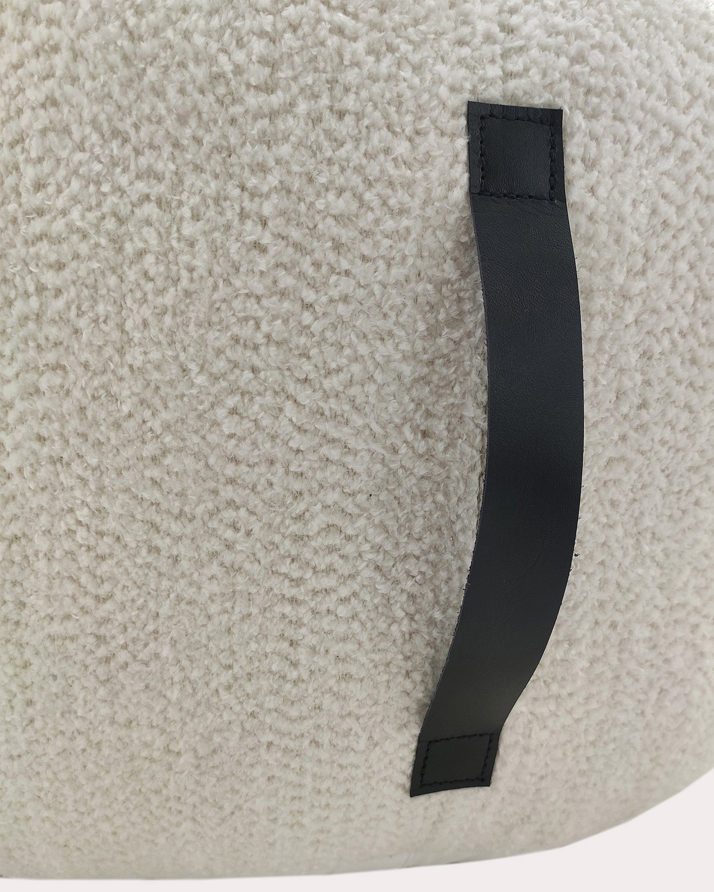 Close-up view of the handmade white cotton pouf showing fine woven texture and neat stitching details.