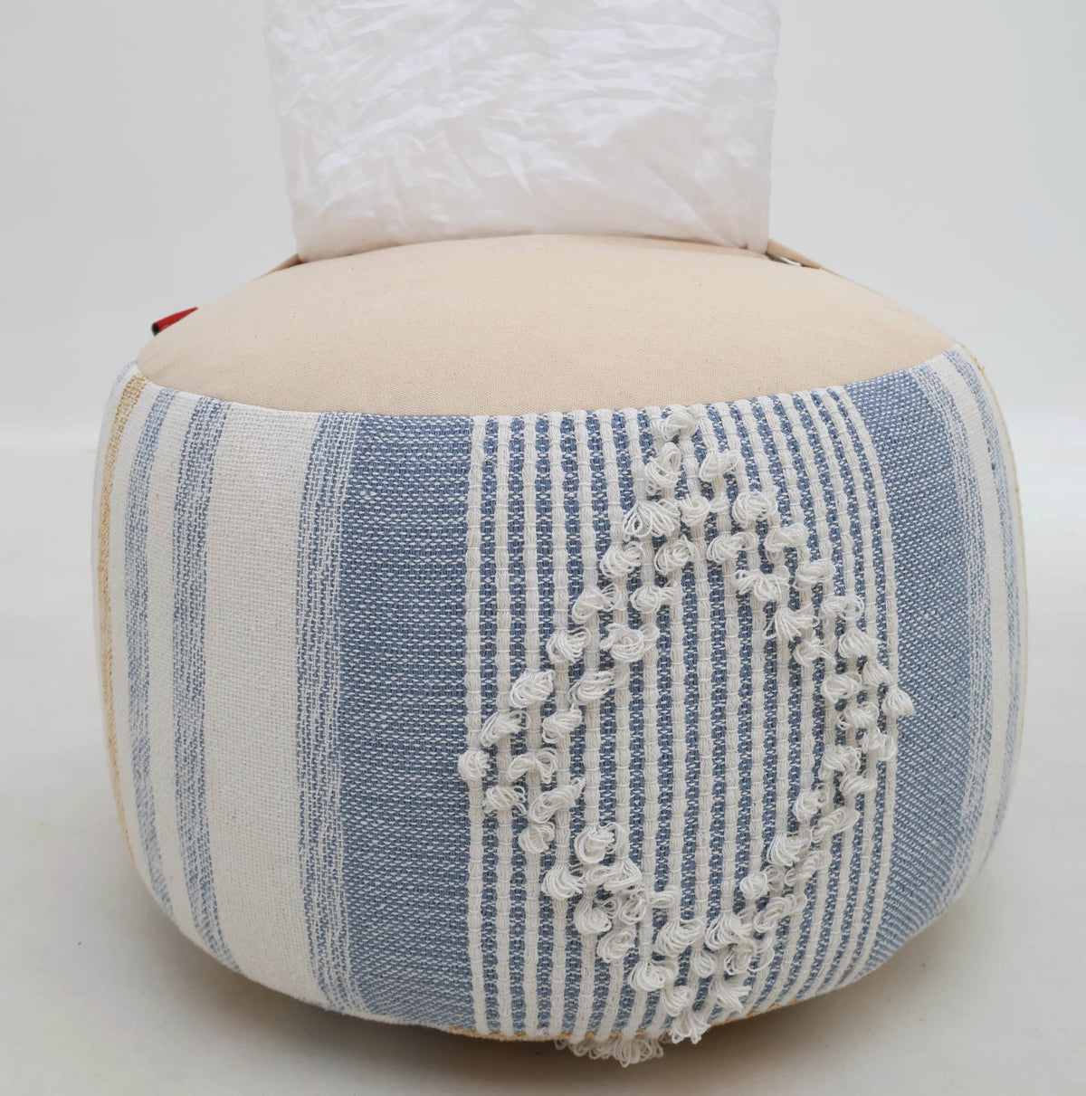 The RAMSHA HOME Boho Modern Round Pouf With Insert PF 109, featuring blue and white striped fabric with a raised diamond pattern, serves as a stylish decorative accent while offering extra seating when needed.