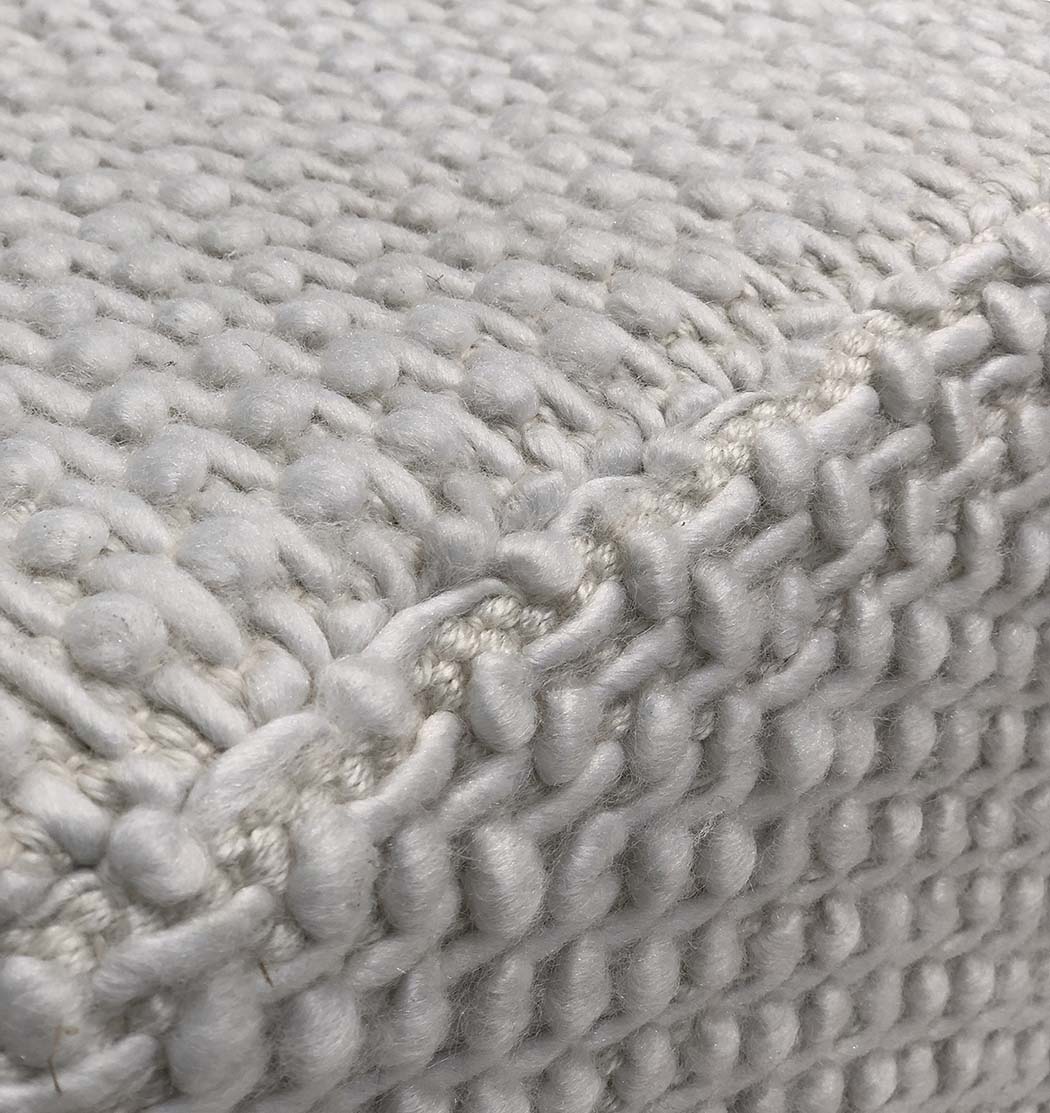 Top detail of grey PF-129 pouf highlighting cushion surface and weave pattern