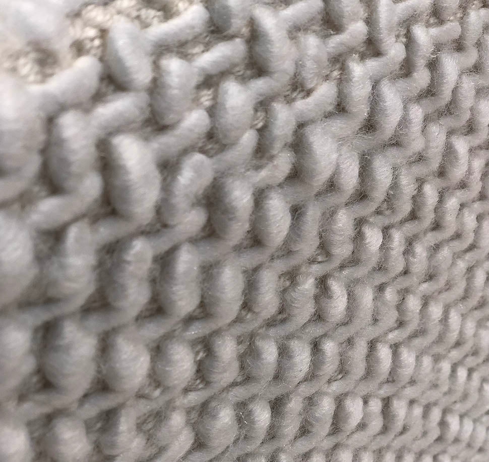 Rear side of grey square pouf PF-129 highlighting handcrafted stitching