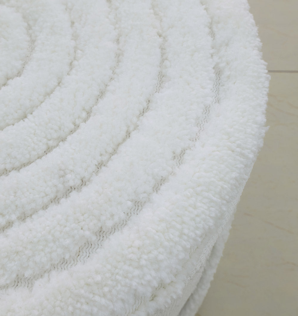 Close-up of the RAMSHA HOME Luxury Handmade Pouf with Thermocol Bean Bag Insert PF-148—its round, white, textured surface and thick, fluffy pattern add an inviting premium touch to any space.