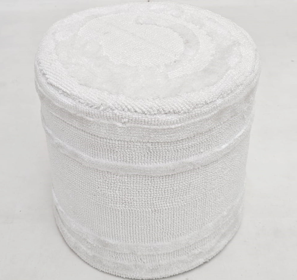 The RAMSHA HOME Luxury Handmade Pouf with Thermocol Bean Bag Insert PF-150 is a white cylindrical décor accent with a textured woven surface, adding elegance to any light-colored floor.