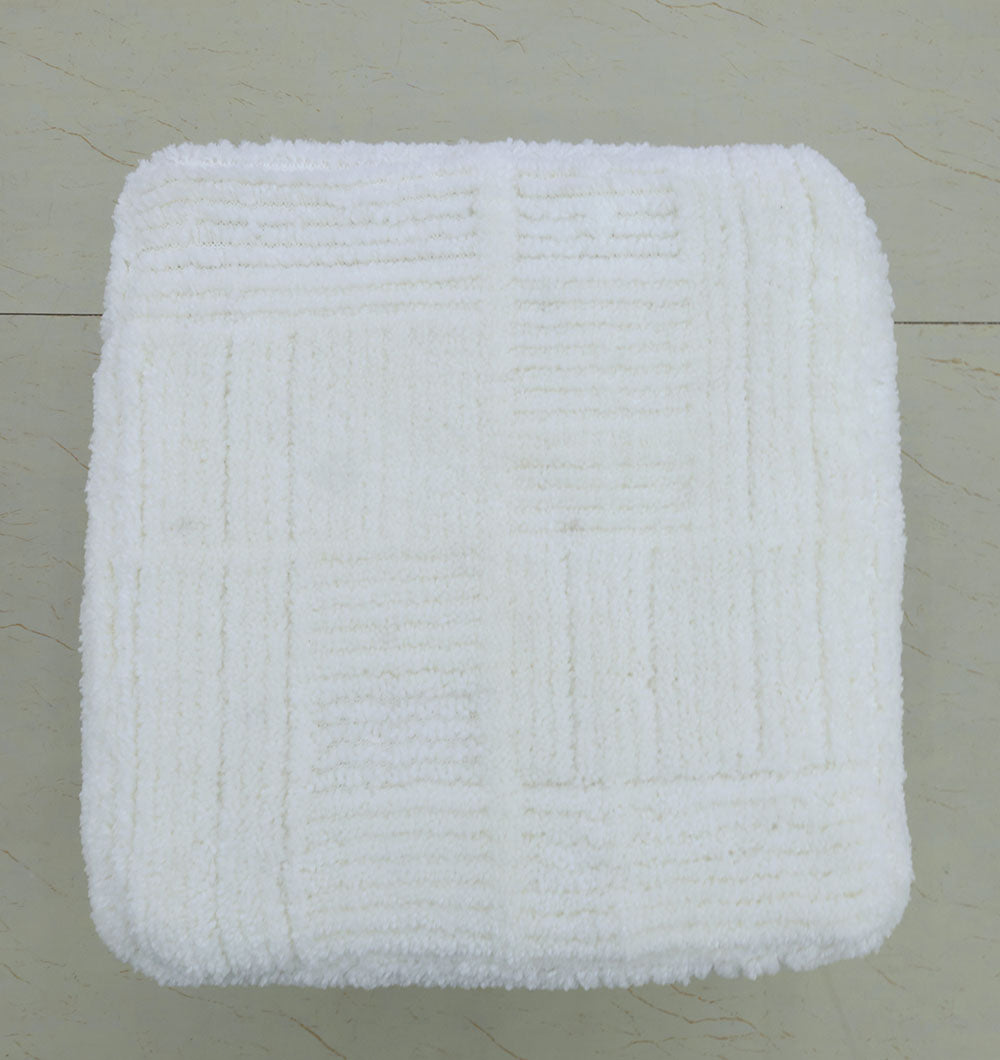 The RAMSHA HOME Handmade Pouf with Insert (White PF-154) adds premium style to your home décor, featuring a textured geometric design and looking elegant on light-colored tiled floors.