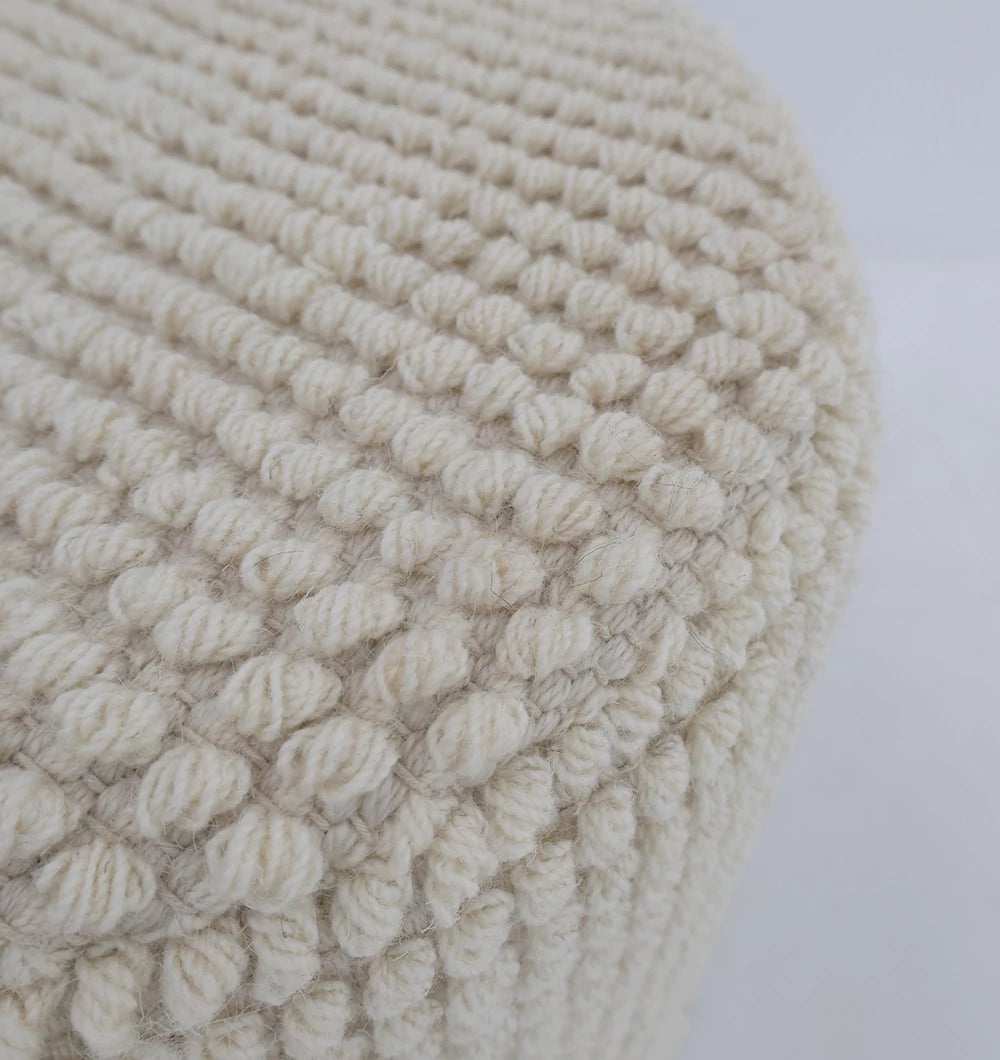 Close-up of the RAMSHA HOME Handwoven White Macrame Pouf with Bean Bag Insert PF 161, featuring a round, textured chunky yarn design in cream-white, set against a plain white background.