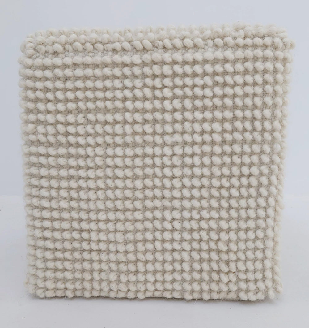 A square, beige pouf ottoman with a chunky knit pattern pairs perfectly with the RAMSHA HOME Handwoven White Macrame Pouf with Bean Bag Insert PF 162, both shown against a plain white background.
