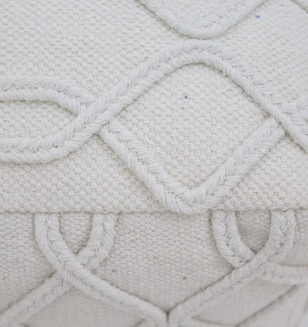 Close-up of the Ivory Nordic Bliss Cotton Pouf with insert PF 167 by RAMSHA HOME, featuring textured white fabric with raised, rope-like geometric patterns—an ideal decorative accent for any space.