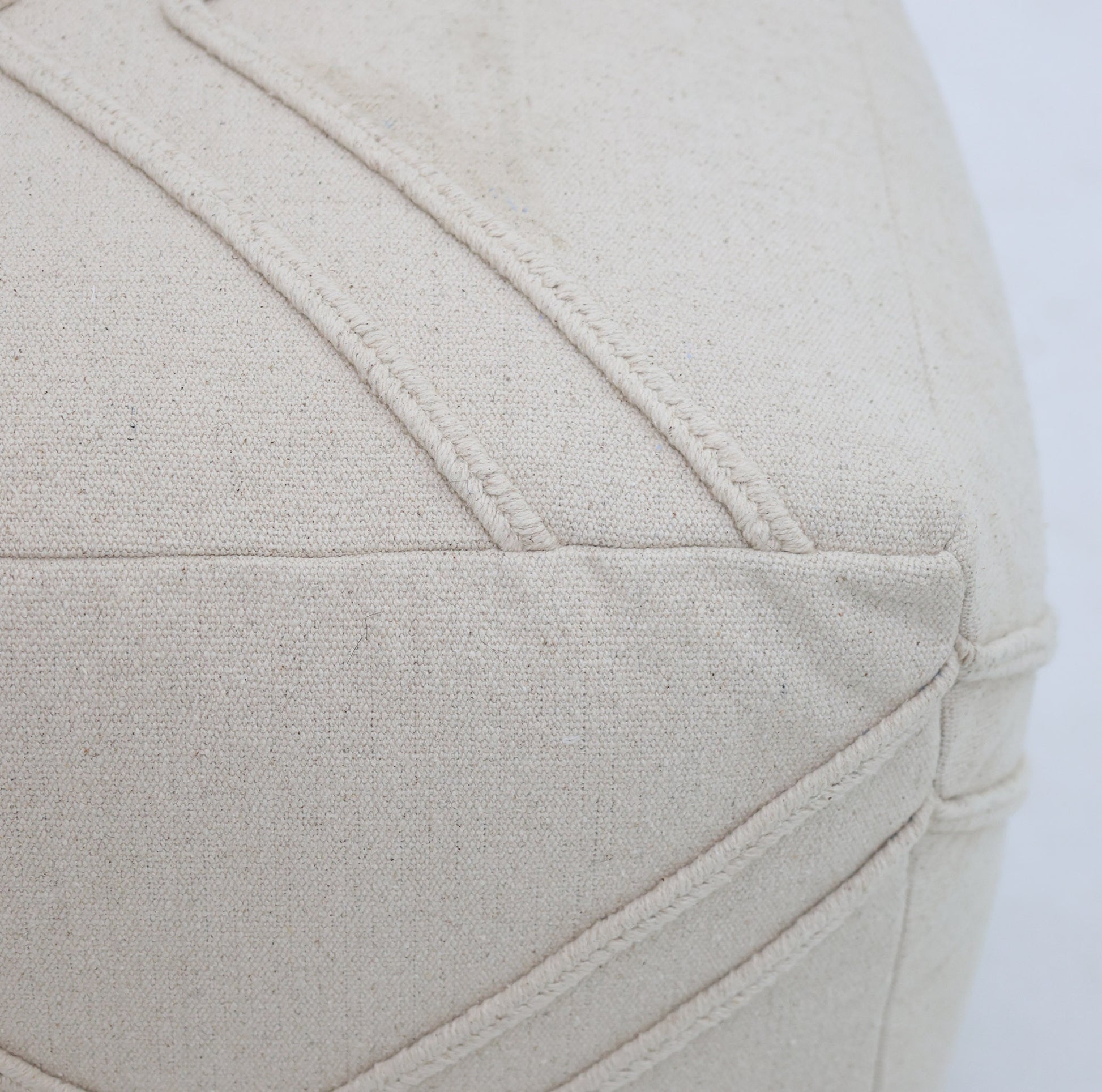 Close-up of the RAMSHA HOME Ivory Nordic Bliss Cotton Pouf with insert PF 172, showcasing textured stitching, detailed seams, and fabric grain—an elegant decorative accent for any space.