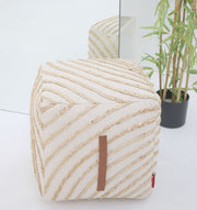 The Aurora Cotton Floor Pouf with insert PF 173 by RAMSHA HOME sits in front of a mirror next to a green potted plant, creating a stylish modern décor look. The mirror reflects both the pouf and plant for added dimension.