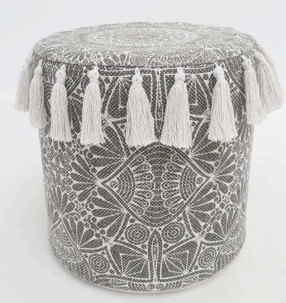 The RAMSHA HOME Stylish cotton printed pouf with decorative tassels PF 174 features a round boho design with gray and white geometric and floral patterns, plus white fringe tassels—perfect as a decorative floor cushion.