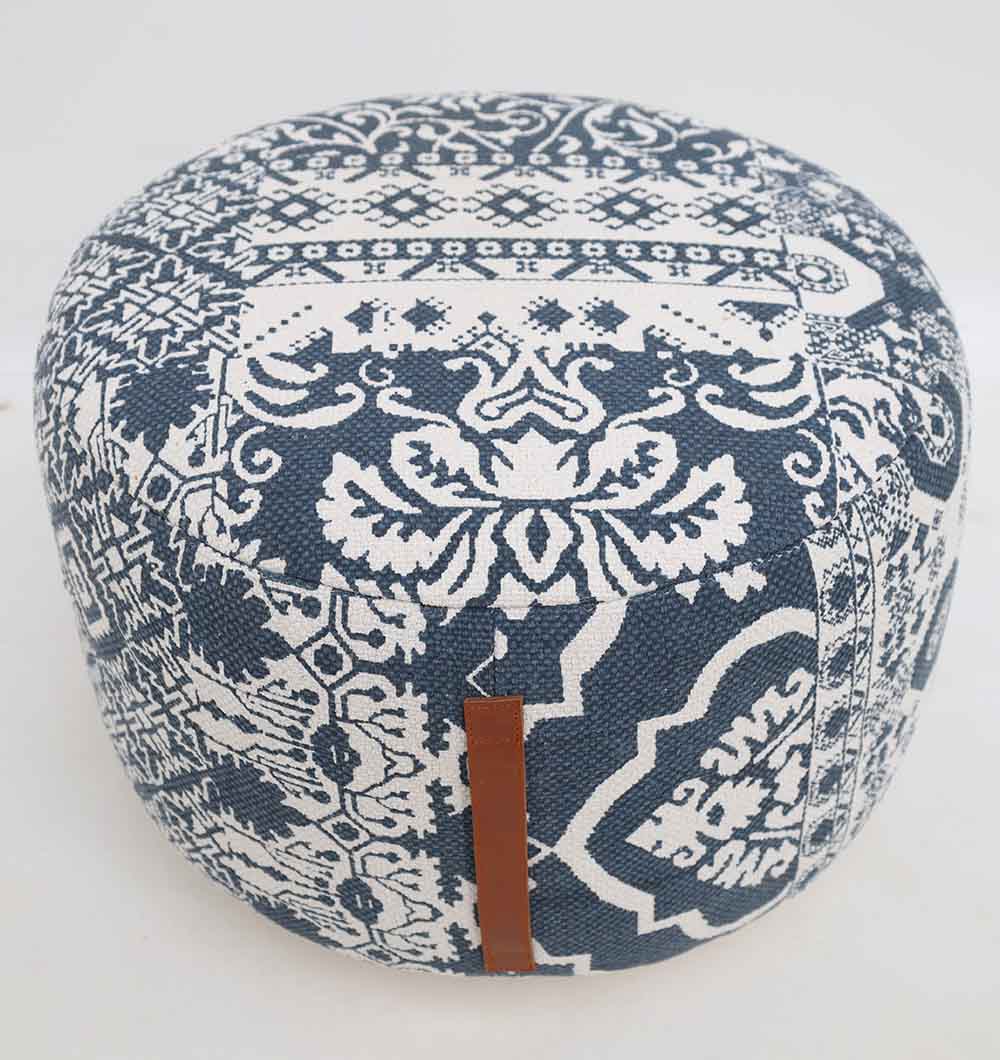 The Boho Printed Round Pouf with Insert PF 176 by RAMSHA HOME features blue and white geometric and floral patterns, a round design, and a small brown leather side strap—a stylish décor accent for any home.
